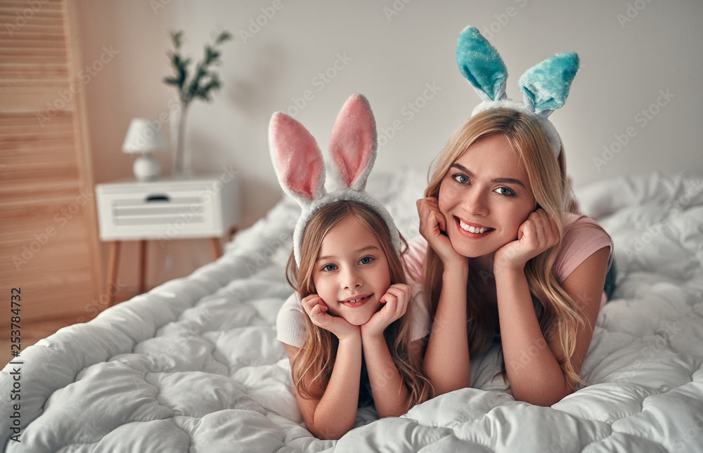 Mother with daughter on bed