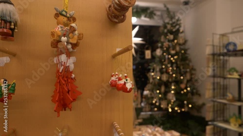 Panning down shot: wooden christmas ornaments inside of a traditional bavarian toy shop. photo