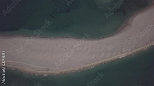 Aerial top view of the beach at the beautiful Arrábida Natural Park, Outão in Setúbal, Portugal with drone slowly descending photo