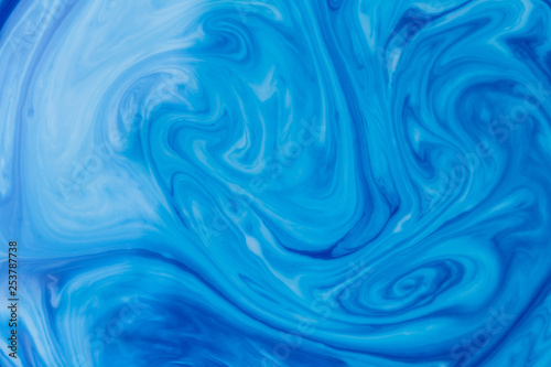 Blue liquid ink swirl abstract background © photopsist