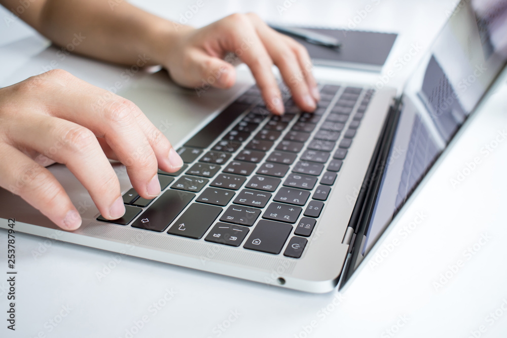 The close-up image of the hand that is working on the laptop seriously in business concepts. The close-up image of the hand that is working on the laptop seriously in business concepts.