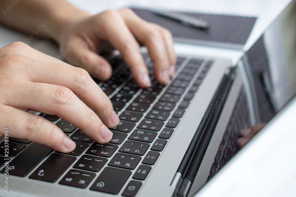 The picture is close-up to the hands of the person working on the laptop seriously. In business concepts. The picture is close-up to the hands of the person working on the laptop seriously. In business concepts.