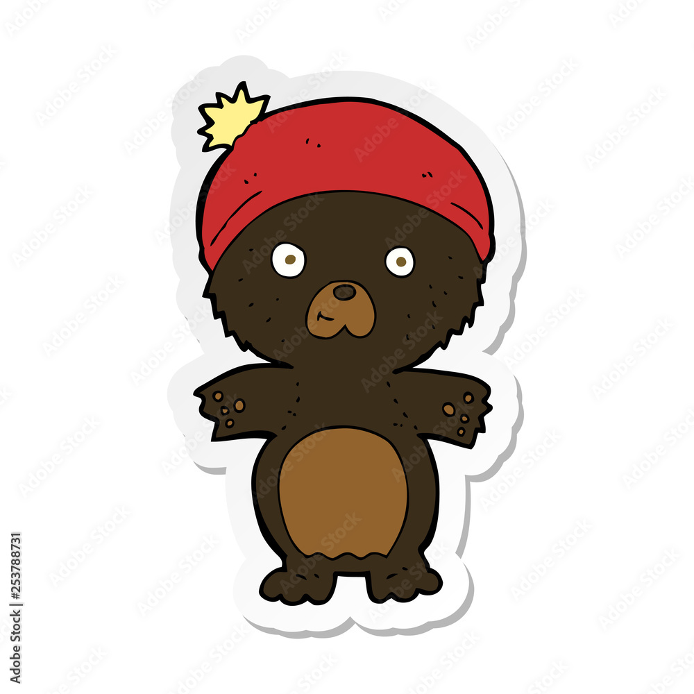 Obraz premium sticker of a cartoon cute black bear in hat