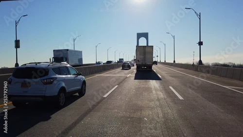 POV Driving Forward Over a Bridge in Daylight photo