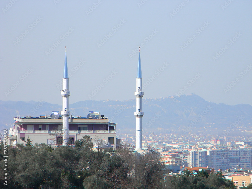 The minarets of a mosque with residential buildings in the background, Tirana, Albania