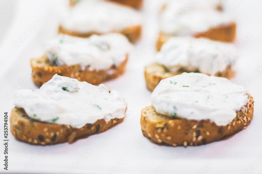 Cream cheese with herbs on a white bread Cream cheese with herbs on a white bread