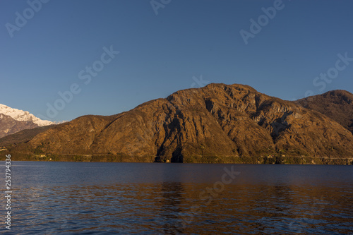 Italy, Lecco, Lake Como, a large body of water with a mountain in the background