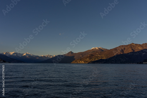 Italy  Lecco  Lake Como  a large body of water with a mountain in the background