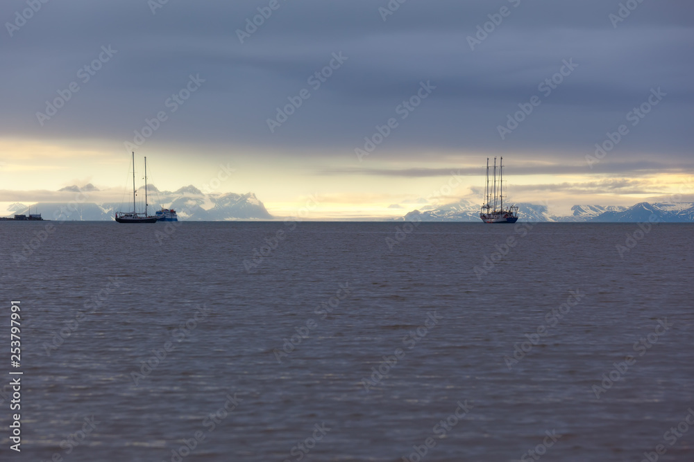 ships in the bay fjord of Longyearbyen Svablbard of Norway at sunset