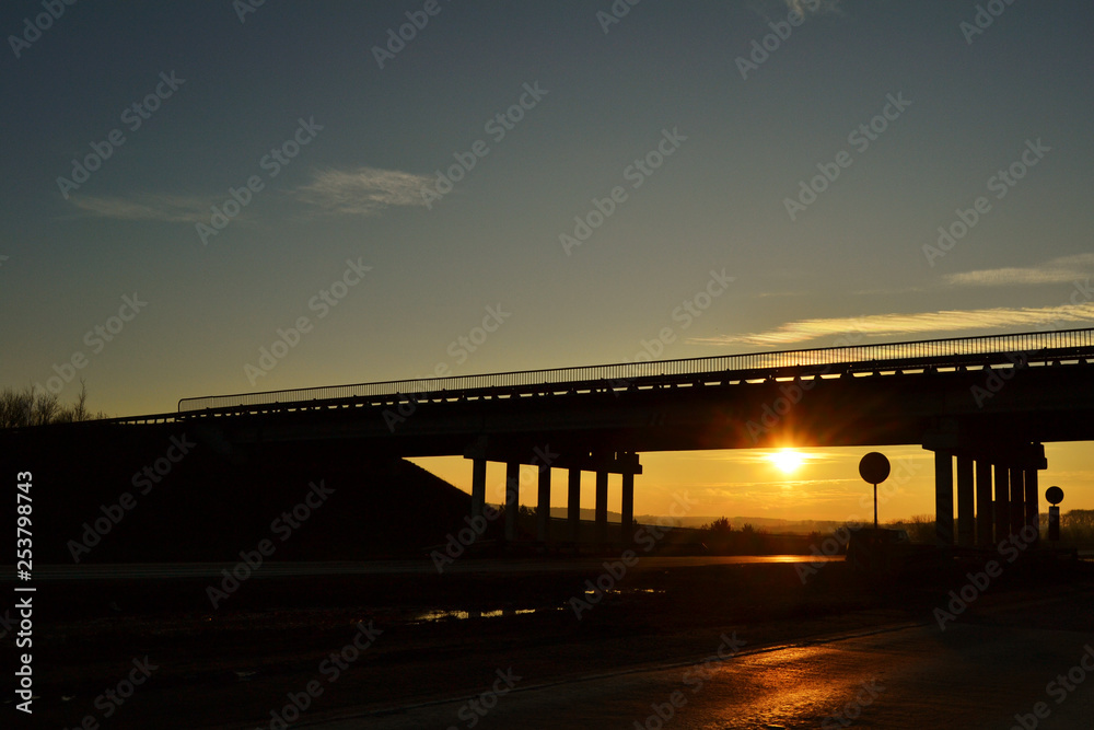 road across the bridge at sunset