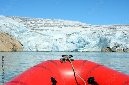 Sailing on an inflatable boat among the icebergs, Greenland photo