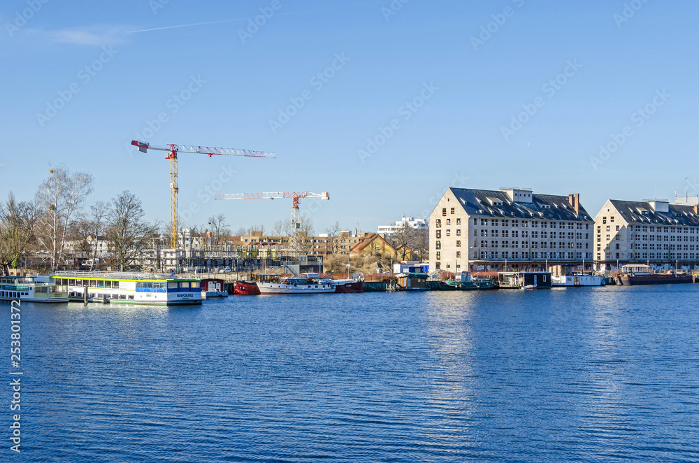 River Havel with the former storehouse of the army rations department, tourist boats and  tower cranes from a newly erected district