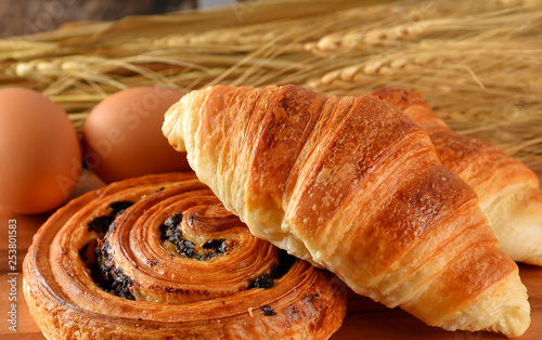 fresh bread danish and croissant wheat on the wooden.