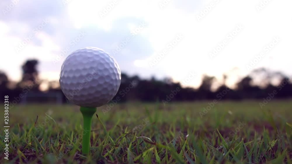 Golfer placing golf ball on tee at golf course footage slow motion Golfer placing golf ball on tee at golf course footage slow motion