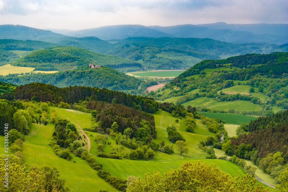 Great panoramic landscape view at Hanstein Castle ruin which is surrounded by beautiful woodland, the Werra Valley and the Hessian low mountains. On the far left the Ludwigstein Castle can be seen.
