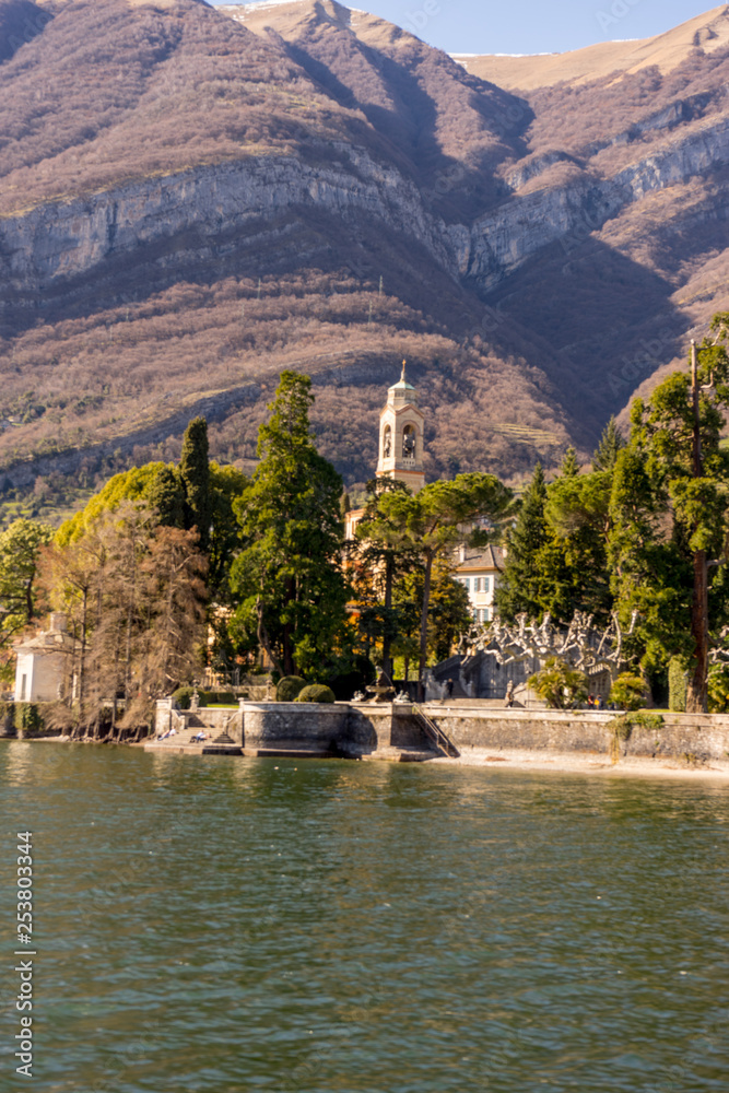 Italy, Lecco, Lake Como, a body of water with a mountain in the background