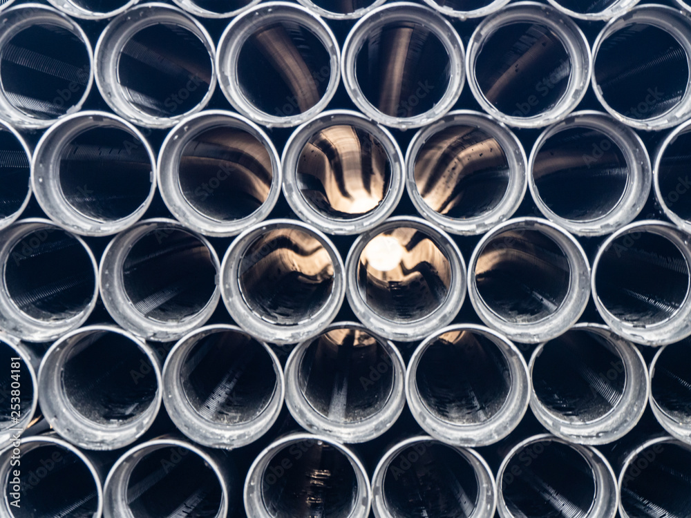 Black plastic pipes of various diameters in a row Black plastic pipes of various diameters in a row