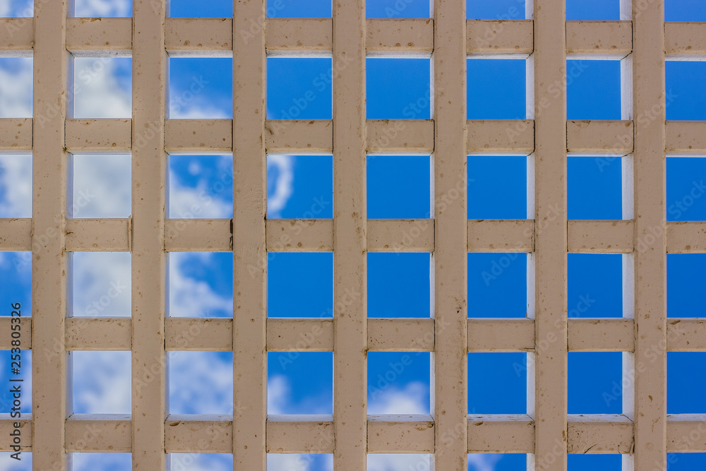 white old dirty grid industrial object from below foreshortening on blue sky background vivid colorful and bright photography white old dirty grid industrial object from below foreshortening on blue sky background vivid colorful and bright photography