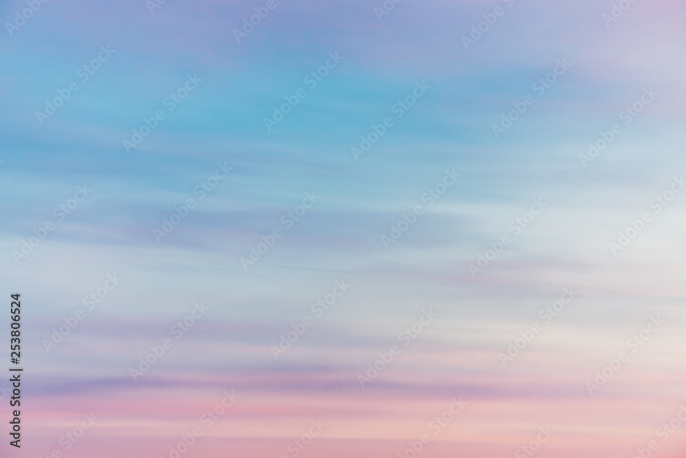 Sunset sky with pink violet light clouds. Colorful smooth blue sky gradient. Natural background of sunrise. Amazing heaven at morning. Slightly cloudy evening atmosphere. Wonderful weather on dawn.