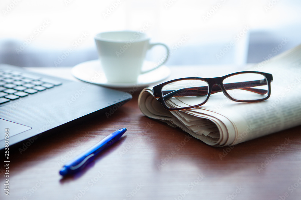 Newspaper with computer on table. Coffee break. Newspaper with computer on table. Coffee break.