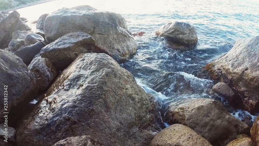 Rocky seashore and sea water splashing between the stones Rocky seashore and sea water splashing between the stones