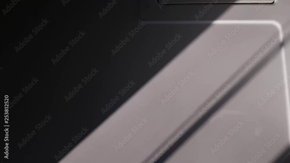 Lift cord shadow swinging on white surface slomo Lift cord shadow swinging on white surface slomo