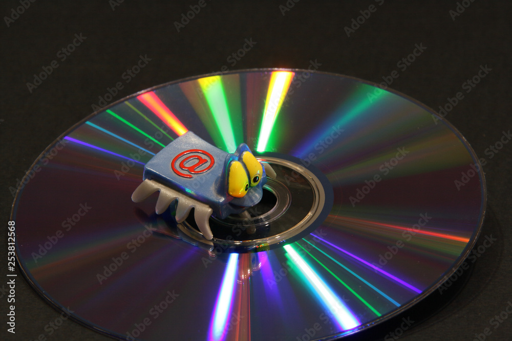 CD with color beams and electronic key on a dark background. Correction fluid,electronic key, DVD with color rays of a rainbow, a notebook,record marker and a pen on a dark background CD with color beams and electronic key on a dark background. Correction fluid,electronic key, DVD with color rays of a rainbow, a notebook,record marker and a pen on a dark background
