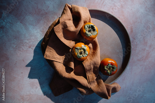 Persimmons on Terracotta and Linen
