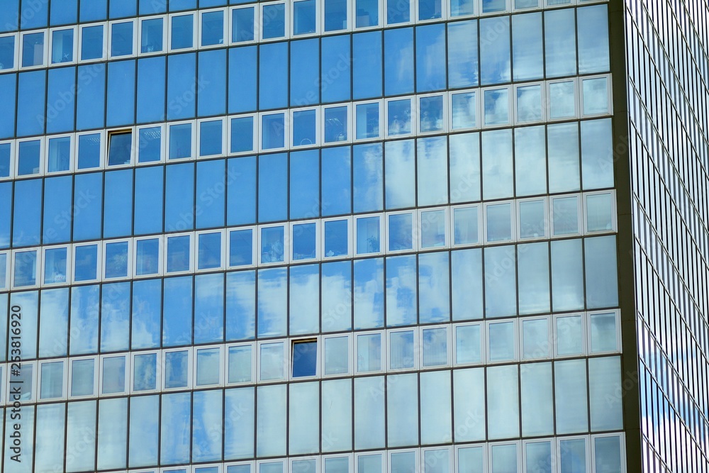 Surface of glass building with the reflection of clouds Surface of glass building with the reflection of clouds