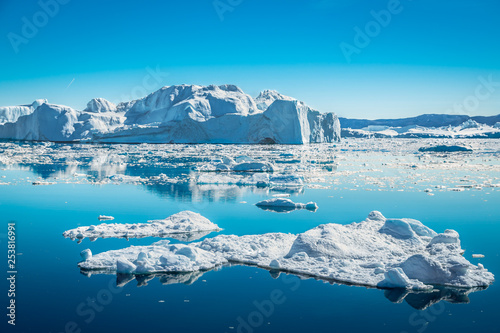 Icebergs off the glacier flowing on the open ocean near Ilulissat icefjord, Greenland