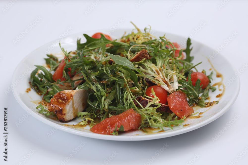 restaurant dish, green salad, cucumbers, red pepper, boiled meat, arugula, tomato and grapefruit, healthy food, close-up, for the menu restaurant dish, green salad, cucumbers, red pepper, boiled meat, arugula, tomato and grapefruit, healthy food, close-up, for the menu