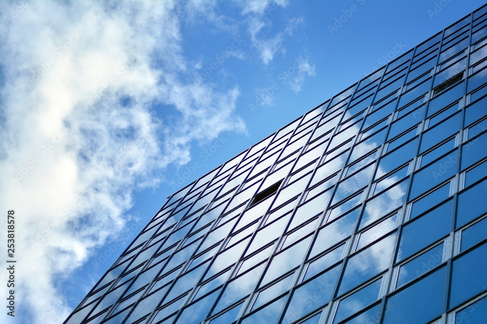 Surface of glass building with the reflection of clouds Surface of glass building with the reflection of clouds