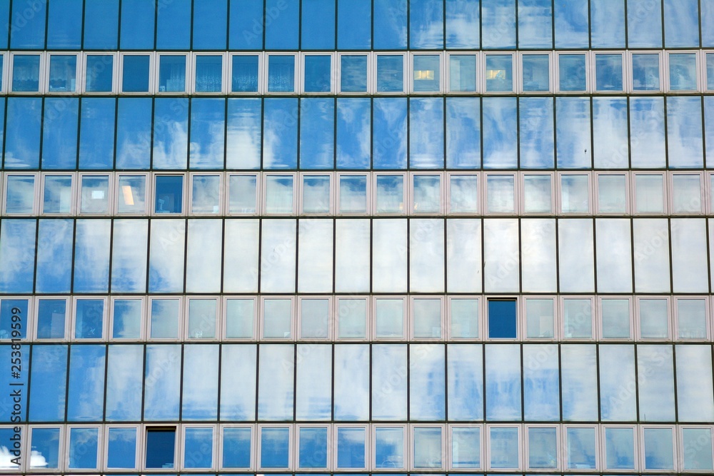 Surface of glass building with the reflection of clouds Surface of glass building with the reflection of clouds