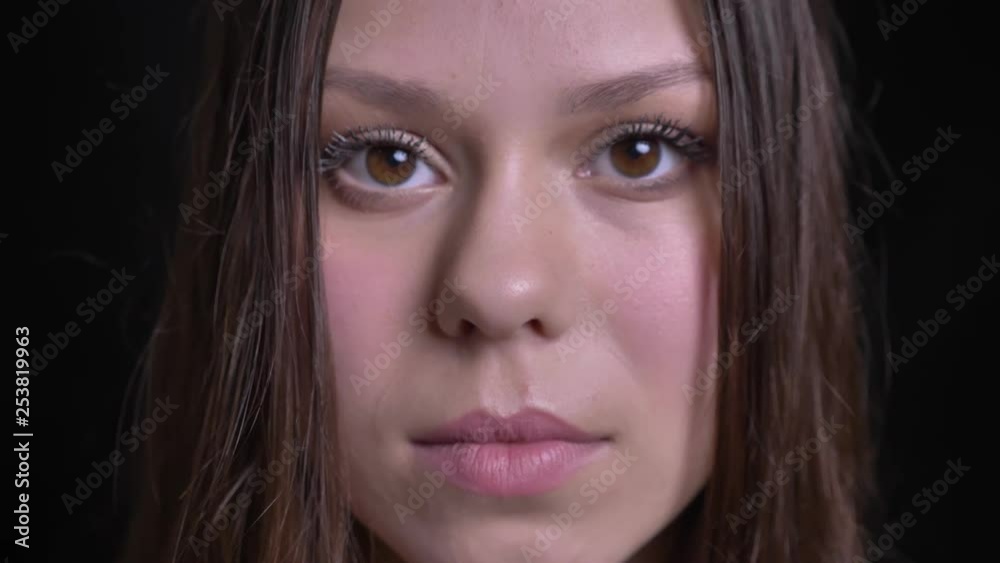 Closeup shoot of adult beautiful caucasian female face with brown eyes looking straight at the camera and smiling cheerfully Closeup shoot of adult beautiful caucasian female face with brown eyes looking straight at the camera and smiling cheerfully