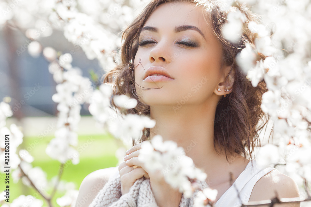Woman beauty portrait. Young girl outdoor at spring background. Female with flowers. Beautiful lady closeup portrait. Woman beauty portrait. Young girl outdoor at spring background. Female with flowers. Beautiful lady closeup portrait.