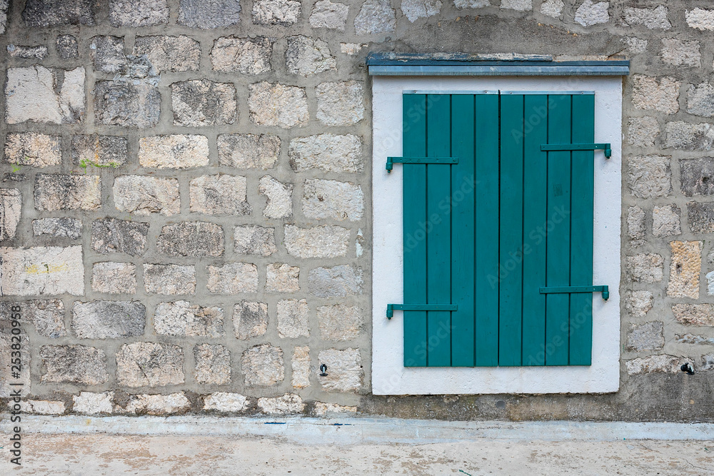 Authentic, stone wall, with beautiful, old, wooden shutters and window, minimal style, bright colors, background.