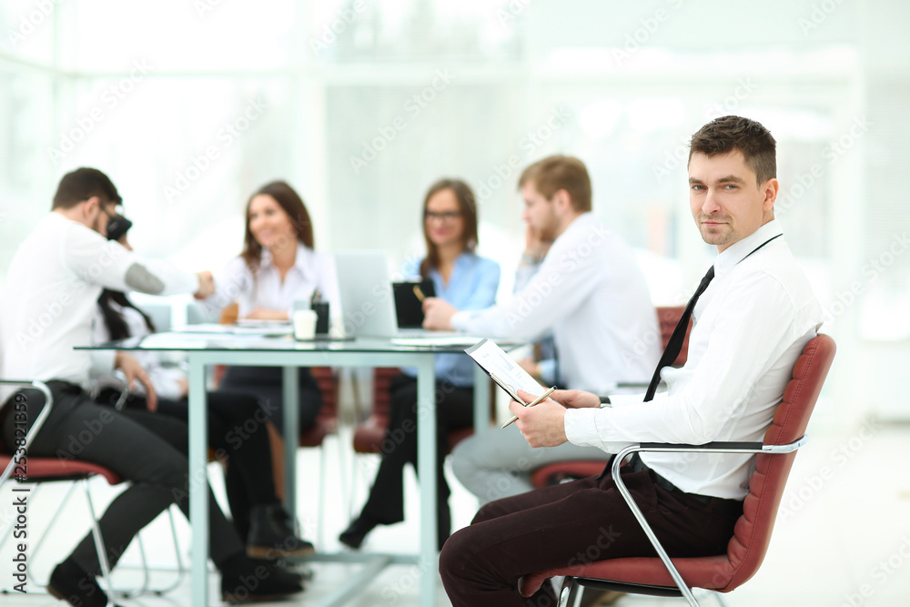 young businessman reading a document sitting in his office.business concept young businessman reading a document sitting in his office.business concept