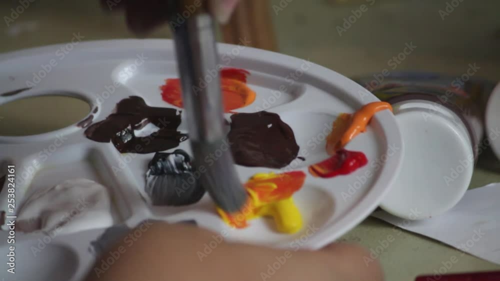 Mixing paints with a paint brush. This is acrylic paint but can be like thinned oil paint. Mixing paints with a paint brush. This is acrylic paint but can be like thinned oil paint.