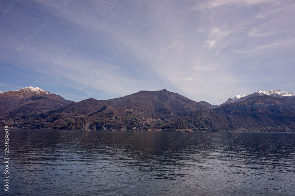 Italy, Menaggio, Lake Como, a body of water with a mountain in the background