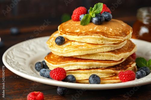 Homemade american blueberry, raspberries pancakes. Healthy morning breakfast. rustic style.