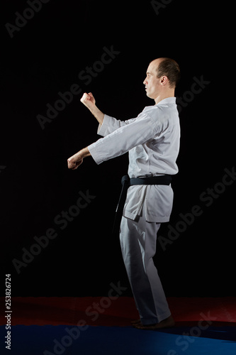 In karategi, an athlete does formal karate exercises on red and blue tatami