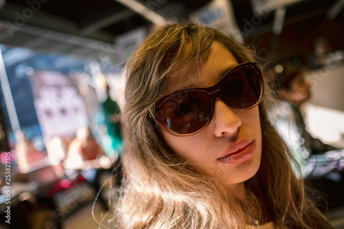 portrait of young woman in sunglasses smile moment expression face look white girl blonde travel shopping buying enjoy