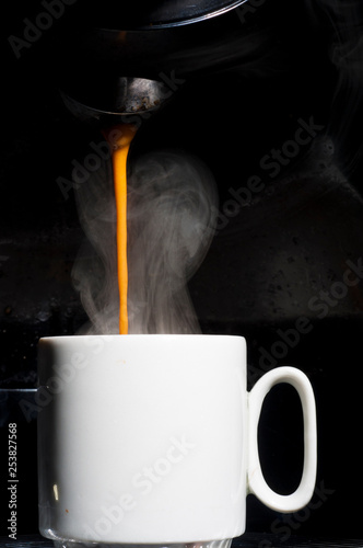 cup of coffee with smoke on black background