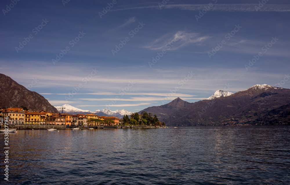 Italy, Menaggio, Lake Como, a large body of water with a mountain in the background