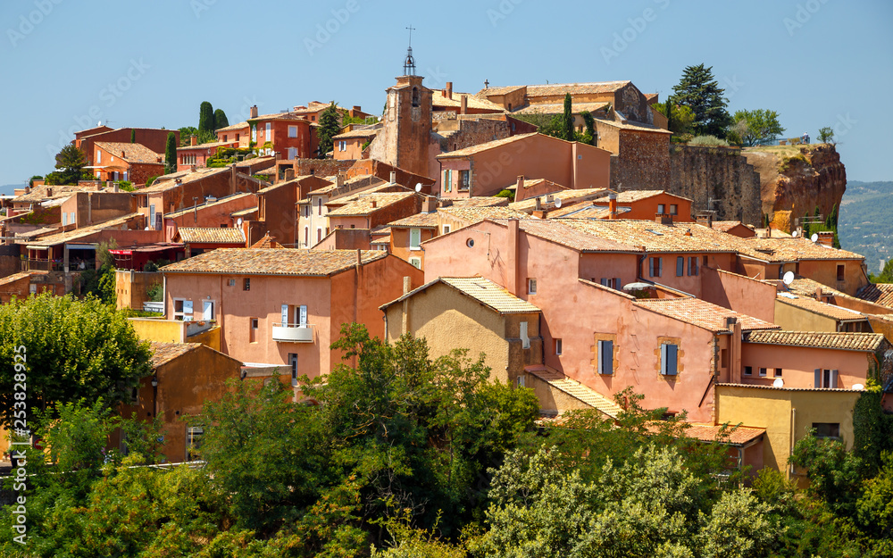 Panoramic view of hilltop medieval ochre village of Roussillon one of the most beautiful villages of France in a sunny summer day. Provence, travel France.