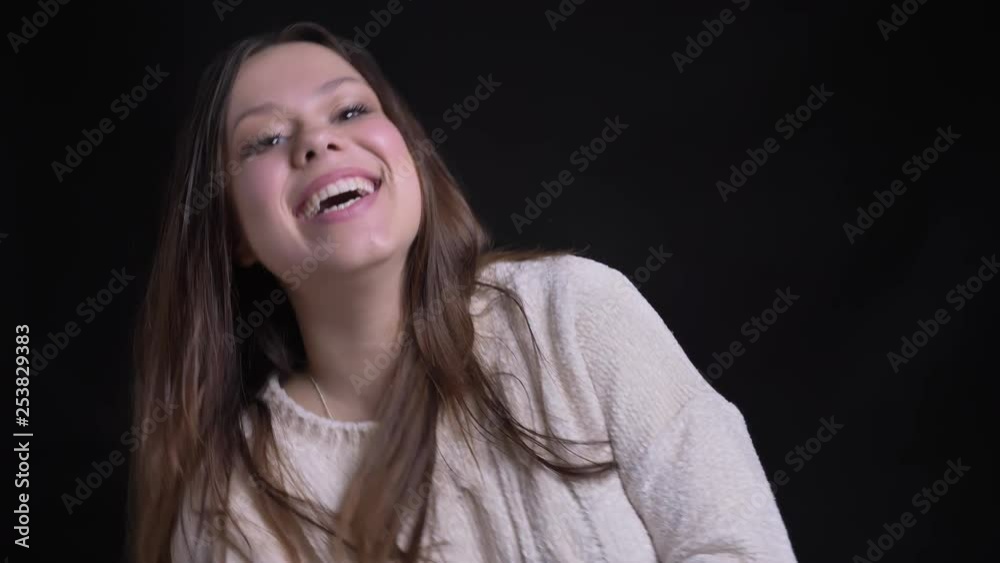 Closeup portrait of adult attractive caucasian female laughing happily and having fun in front of the camera Closeup portrait of adult attractive caucasian female laughing happily and having fun in front of the camera