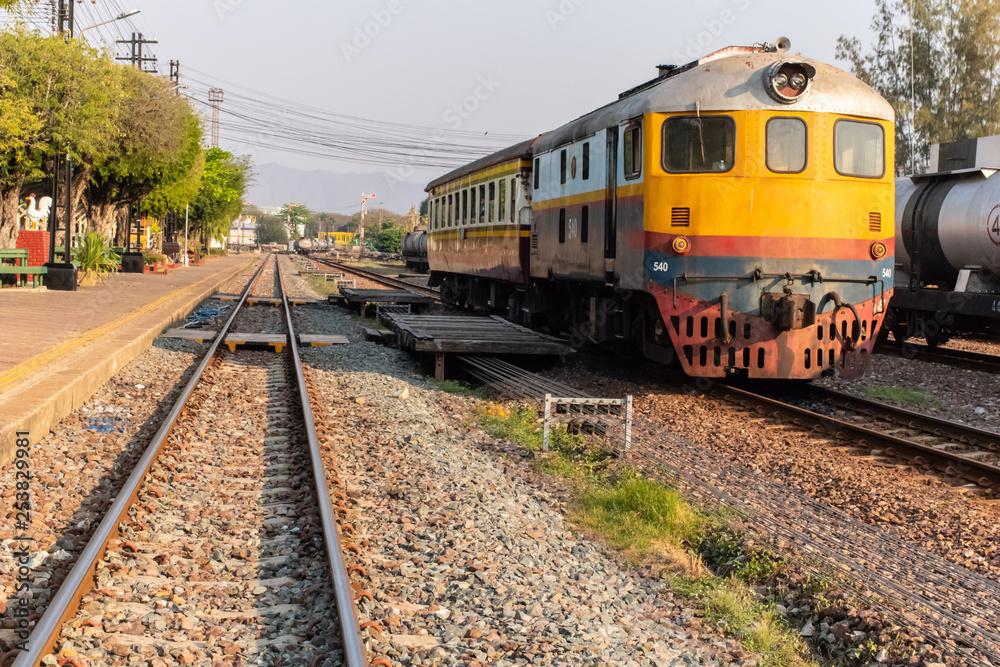Locomotive parked on the railway tracks. Locomotive in the train station. Locomotive parked on the railway tracks. Locomotive in the train station.