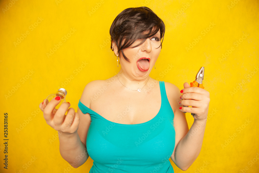 a girl with a light bulb and pliers in his hands trying to figure out how to fix a girl with a light bulb and pliers in his hands trying to figure out how to fix