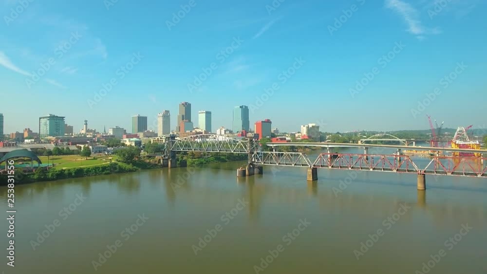 Low to high aerial shot overlooking the Arkansas River on a clear day, with the Little Rock cityscape on the horizon. Low to high aerial shot overlooking the Arkansas River on a clear day, with the Little Rock cityscape on the horizon.