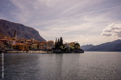 Italy, Menaggio, Lake Como, a large body of water with a mountain in the background